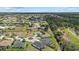 Wide aerial view of the neighborhood featuring well-maintained homes, lush greenery, and community waterways at 7443 S Seagrape Rd, Punta Gorda, FL 33955