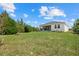 The house has a spacious backyard with green grass at 7443 S Seagrape Rd, Punta Gorda, FL 33955