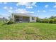 View of the well-maintained backyard and screened patio of the home at 7443 S Seagrape Rd, Punta Gorda, FL 33955