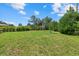 A view of the lush green backyard on a sunny day at 7443 S Seagrape Rd, Punta Gorda, FL 33955