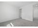 Bright bedroom with gray carpet, white walls, trim, and a closet with doors at 7443 S Seagrape Rd, Punta Gorda, FL 33955