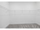 Bright empty walk-in closet features wire shelving and gray carpet at 7443 S Seagrape Rd, Punta Gorda, FL 33955