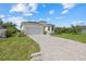 A well-maintained house with a large driveway and well-manicured front lawn at 7443 S Seagrape Rd, Punta Gorda, FL 33955