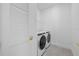 Bright laundry room with white washer, dryer, and wire shelving at 7443 S Seagrape Rd, Punta Gorda, FL 33955