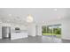 Open living room and kitchen with stainless steel appliances, granite counters, and natural light at 7443 S Seagrape Rd, Punta Gorda, FL 33955