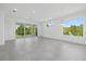 Bright living room with tile floors, sliding glass doors to backyard, and modern lighting at 7443 S Seagrape Rd, Punta Gorda, FL 33955