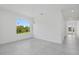 Bright living room with tile floors, a large window and modern lighting at 7443 S Seagrape Rd, Punta Gorda, FL 33955