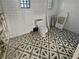 Bathroom under renovation with tile floor, toilet, and unique square patterned tile walls at 141 81St N Ave, St Petersburg, FL 33702