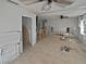 Living room with tile floor, ceiling fan, and window, shown during remodeling stages at 141 81St N Ave, St Petersburg, FL 33702