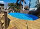 Inviting inground pool with wooden deck and serene outdoor space at 141 81St N Ave, St Petersburg, FL 33702