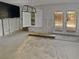Sunroom shown during remodeling stages, with door to backyard, window, and modern chandelier at 141 81St N Ave, St Petersburg, FL 33702