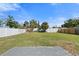 Expansive backyard with green grass, a brick patio, and privacy fencing, ideal for outdoor activities at 1805 Rita St, Sarasota, FL 34231