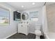 Bright bathroom with modern fixtures, white vanity, and a shower with stylish tile at 1805 Rita St, Sarasota, FL 34231