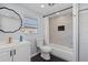 Modern bathroom with a vanity, toilet, and a shower featuring elegant tile work at 1805 Rita St, Sarasota, FL 34231