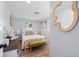Stylish bedroom features a cozy bed, decorative mirror, and ample natural light at 1805 Rita St, Sarasota, FL 34231