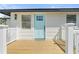 Charming home featuring a light blue front door and a wooden deck for a welcoming entrance at 1805 Rita St, Sarasota, FL 34231