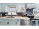 Kitchen featuring stainless steel appliances, hexagon backsplash, and lots of natural light at 1805 Rita St, Sarasota, FL 34231