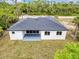 Aerial view of the back of the house, showcasing the backyard and covered patio area at 18399 Hillsborough Blvd, Port Charlotte, FL 33954