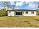 A spacious backyard features a stucco home with a dark roof at 18399 Hillsborough Blvd, Port Charlotte, FL 33954