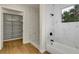 Bathroom featuring tiled walk-in shower, soaking tub, and closet at 18399 Hillsborough Blvd, Port Charlotte, FL 33954