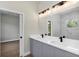 Bathroom featuring double sinks, modern fixtures and a large vanity mirror at 18399 Hillsborough Blvd, Port Charlotte, FL 33954