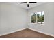 A bright, airy bedroom features a large window letting in light and a view of the outdoors at 18399 Hillsborough Blvd, Port Charlotte, FL 33954