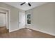 This bedroom offers a ceiling fan, wood floors, and a well-lit window with a view at 18399 Hillsborough Blvd, Port Charlotte, FL 33954