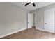 Bright bedroom offering wood-look floors, a ceiling fan, and two doors at 18399 Hillsborough Blvd, Port Charlotte, FL 33954