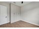A well lit bedroom with wood-look floors and closet storage space at 18399 Hillsborough Blvd, Port Charlotte, FL 33954