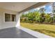 View from covered patio offering a glimpse of the backyard landscaping and outdoor space at 18399 Hillsborough Blvd, Port Charlotte, FL 33954