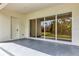 Covered patio with a back door and sliding glass doors providing seamless access to the backyard at 18399 Hillsborough Blvd, Port Charlotte, FL 33954