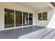 Covered patio showcasing large sliding glass doors and recessed lighting for indoor/outdoor living at 18399 Hillsborough Blvd, Port Charlotte, FL 33954
