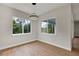 Dining area featuring wood floors, natural light and views of the surrounding lush landscape at 18399 Hillsborough Blvd, Port Charlotte, FL 33954