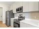 Modern kitchen features stainless steel appliances and stylish backsplash at 18399 Hillsborough Blvd, Port Charlotte, FL 33954