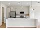 Contemporary kitchen featuring stainless steel appliances, a spacious island and modern lighting at 18399 Hillsborough Blvd, Port Charlotte, FL 33954