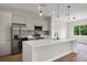 Modern kitchen with stainless steel appliances, a white quartz countertop and pendant lighting at 18399 Hillsborough Blvd, Port Charlotte, FL 33954