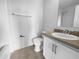 Bathroom with a sink, vanity, toilet, mirror, and towel bar at 8869 White Sage Loop, Lakewood Ranch, FL 34202