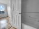 Bathroom view from open door showcasing shower/tub and a window at 8869 White Sage Loop, Lakewood Ranch, FL 34202
