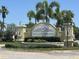 Elegant stone entrance sign for Willowbrook community, surrounded by lush landscaping and palm trees at 8869 White Sage Loop, Lakewood Ranch, FL 34202