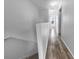 Hallway with wood floors and white walls at 8869 White Sage Loop, Lakewood Ranch, FL 34202