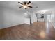Spacious living room with wood floors, ceiling fan, and staircase leading to the upper level at 8869 White Sage Loop, Lakewood Ranch, FL 34202