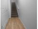 Stairway with carpeted steps and wood flooring at the base at 8869 White Sage Loop, Lakewood Ranch, FL 34202