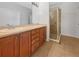 Bathroom features a double sink vanity with wood cabinets and walk-in glass shower at 11535 52Nd E Ct, Parrish, FL 34219