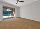 Bright bedroom boasts neutral decor, large sliding glass doors, and access to backyard patio at 11535 52Nd E Ct, Parrish, FL 34219