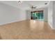 This expansive living room includes neutral decor, tile flooring, and ceiling fan at 11535 52Nd E Ct, Parrish, FL 34219