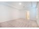 Spacious bedroom featuring a tray ceiling, neutral carpet, and ample natural light at 25372 Alicante Dr, Punta Gorda, FL 33955