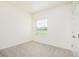 Bright bedroom with neutral carpet and a window offering outdoor views at 25372 Alicante Dr, Punta Gorda, FL 33955