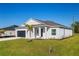 Attractive single-story home with a well-kept lawn and landscaping, as well as a dark gray garage door at 25372 Alicante Dr, Punta Gorda, FL 33955