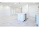 Open-concept kitchen with a large island, stainless steel dishwasher, and tile flooring throughout at 25372 Alicante Dr, Punta Gorda, FL 33955