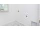 Laundry hookups in a bright, tiled laundry area with a window at 25372 Alicante Dr, Punta Gorda, FL 33955